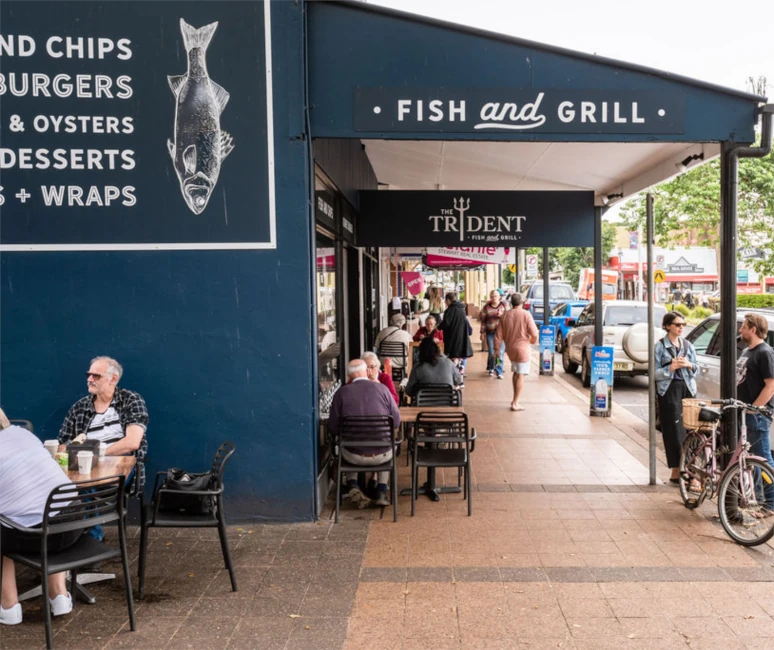 happy patrons sitting outside enjoying a meal